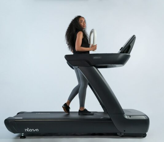 유산소 운동과 근력 운동으로 체력 증진 및 건강 유지 a woman is walking on a treadmill