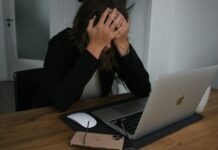 스트레스 관리, 건강한 삶을 위해 꼭 실천해야 할 습관 a woman covering her face while looking at a laptop