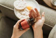 “일과 건강, 선택 아닌 필수” 직장인 건강 관리의 새로운 트렌드 person holding red bottle