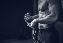 근육, 건강 관리의 새로운 키워드… 일상 속 실천법은? a shirtless man holding a pair of gloves