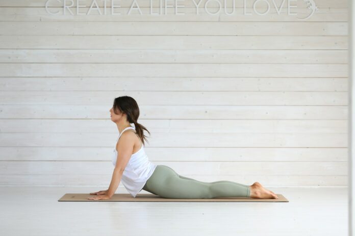 Photo by Margaret Young Woman doing cobra pose on yoga mat