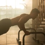 “근육 건강이 곧 활력, 일상에서 실천하는 근육 관리법 주목” a man is doing push ups on a machine