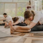직장인에게 인기 급상승, 필라테스가 바꿔놓는 일상 건강 습관 a group of people doing yoga in a room